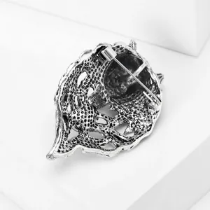 Back detail of vintage alloy wolf head brooch with secure pin clasp mechanism