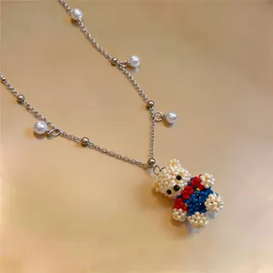 Detailed view of a cute beaded bear pendant necklace with elegant pearl accents