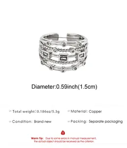 Detailed view of silver-tone multi-layer braided ring with zircon and spec dimensions.