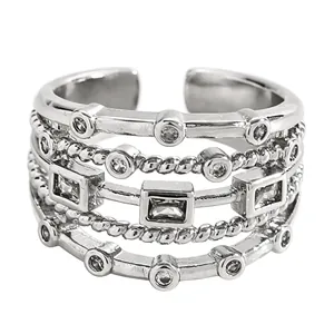 Detailed macro view of silver multi-layer woven ring with clear geometric zircon stones