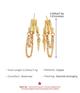 Macro view showing details of gold irregular tassel earrings with zirconia and spike charm