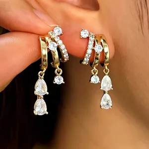 Detailed close-up of stylish gold layered hoop earrings with sparkling cubic zirconia drops