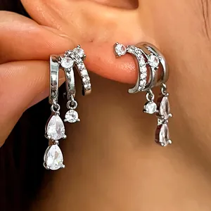 Macro view of a silver hoop earring with cascading cubic zirconia teardrop charms.
