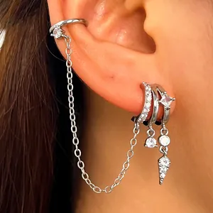 Close-up detail of silver ear cuff and hoop earrings featuring zircon tassels and chain