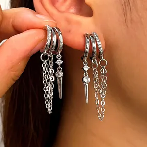 Detailed view of stylish silver tassel hoop earrings with zircon rivets and chains