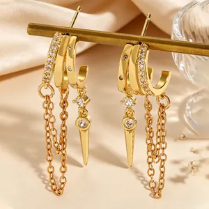 Detail view of gold-plated hoop earrings featuring zircon fringe and spike charms.