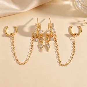 Close-up of elegant gold-toned tassel earrings featuring intricate cubic zirconia and chains