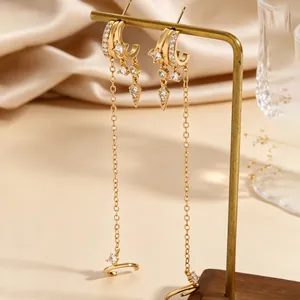 Detailed macro shot of elegant gold tassel earrings featuring sparkling zircon stones.