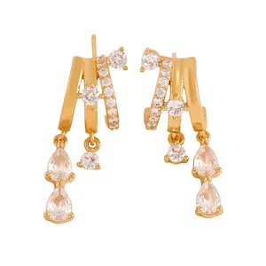 Detail of gold-colored multi-layer hoop earrings with sparkling cubic zirconia tassels