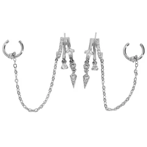 Close-up detail of silver-tone tassel earrings with cubic zirconia studs and ear cuffs.