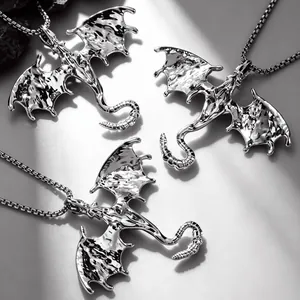 Detailed macro view of the gothic dragon pendant's textured wings and silver finish.