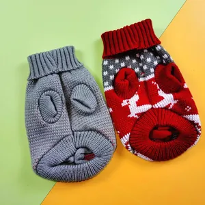 Detailed view of festive red reindeer knit pattern and solid grey warm pet sweaters.