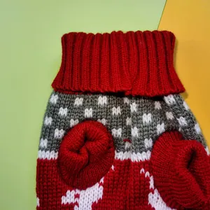 Close-up of red and grey knitted reindeer Christmas sweater for small pets
