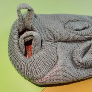 Close-up detail of grey knitted pet Christmas sweater showing high-quality soft yarn texture