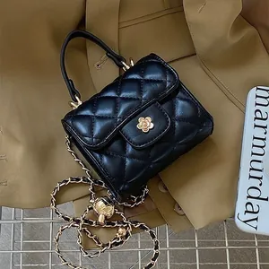 Elegant black quilted mini square bag with gold flower clasp and luxury chain strap
