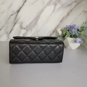 Side view detail of black quilted mini bag with gold-tone clasp and diamond lattice