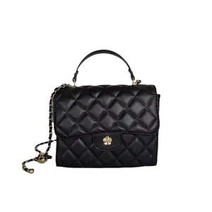 Classic black quilted mini handbag with gold chain strap and elegant flower clasp