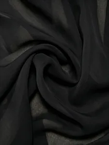 Close-up detail of black sheer chiffon fabric showing lightweight texture and elegant draping