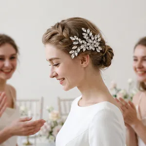 Bride wearing handmade marquise rhinestone leaf hair accessory in elegant wedding setting.