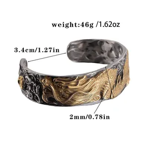 Detailed view of retro dragon relief on stainless steel cuff bracelet showing product thickness