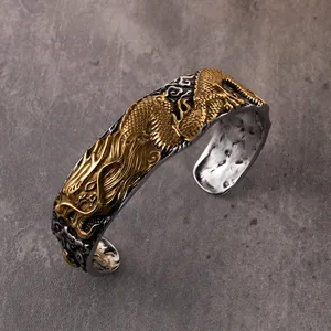 Macro detail of intricate golden dragon relief on vintage silver titanium steel cuff