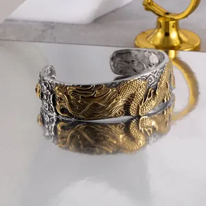 Vintage titanium steel open cuff bracelet with detailed gold dragon relief carving