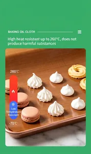 Close-up of reusable non-stick baking oil cloth with cookies and meringues.