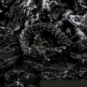 Detailed view of punk dragon bracelet in black titanium steel with golden accents