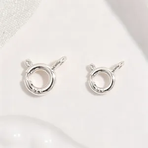 Macro view of two S925 sterling silver spring ring clasps for jewelry making projects