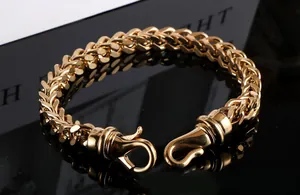 Close-up detail of a men's gold plated titanium steel wheat chain bracelet and clasp