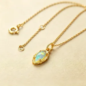 Close-up of a vintage S925 silver marquise opal pendant with golden ridged border