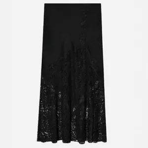 Elegant black satin midi skirt featuring exquisite lace patchwork for a chic evening look