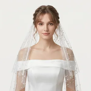 Detailed view of elegant white bridal veil adorned with delicate pearls for wedding ceremonies.