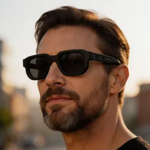 Close-up of a man wearing stylish black square sunglasses with unique arrow temple design detail.