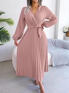 Detailed view of mauve pleated V-neck maxi dress with long sleeves and belted waist