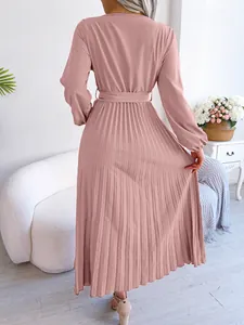 Rear view of an elegant dusty pink long-sleeved pleated maxi dress with belt