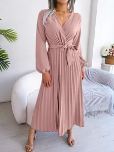 Elegant dusty pink long-sleeved pleated maxi dress with a wrap V-neck and tie waist