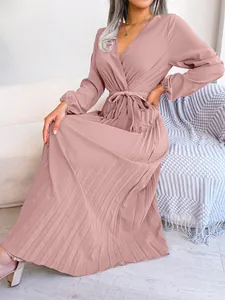 Elegant dusty pink pleated maxi dress featuring a cross V-neck and a stylish tie waist