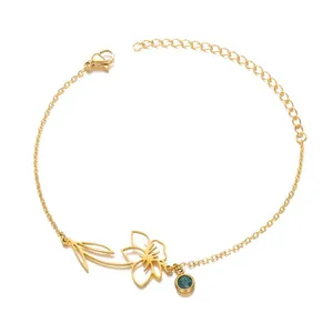 Elegant gold stainless steel December birth flower bracelet with teal birthstone
