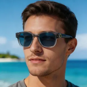 Male model wearing transparent gray square polarized sunglasses on a sunny beach