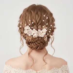 Handgefertigter Brauthaarkamm mit goldfarbenen Blättern und rosa Blumen für Hochzeitsfrisuren