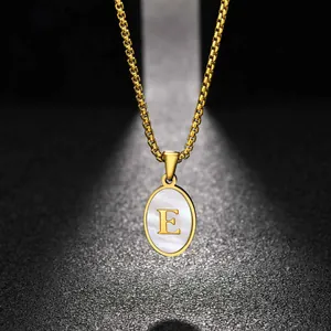 Close-up of gold stainless steel necklace with oval white shell letter E pendant