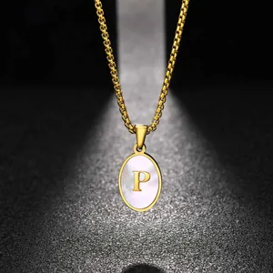 Close-up of stainless steel oval white shell pendant with golden letter P necklace.