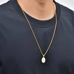 Close-up of gold stainless steel necklace with white shell oval letter A pendant