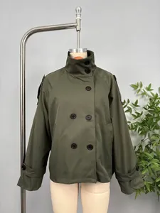 Detailed view of army green double-breasted short trench coat on mannequin display