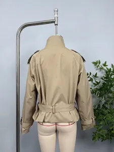 Detailed back view of a stylish khaki double-breasted short trench coat with waist belt