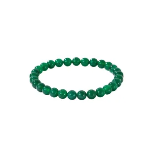 Natural green jasper beaded bracelet with smooth round stones on white background
