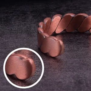 Macro view showing the detailed texture of the vintage copper twisted magnetic ring