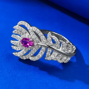 Macro view of an elegant S925 silver feather ring featuring a radiant pink gemstone center.