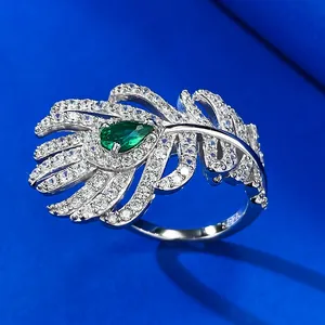 Detailed macro view of S925 silver feather ring featuring a green pear-shaped stone